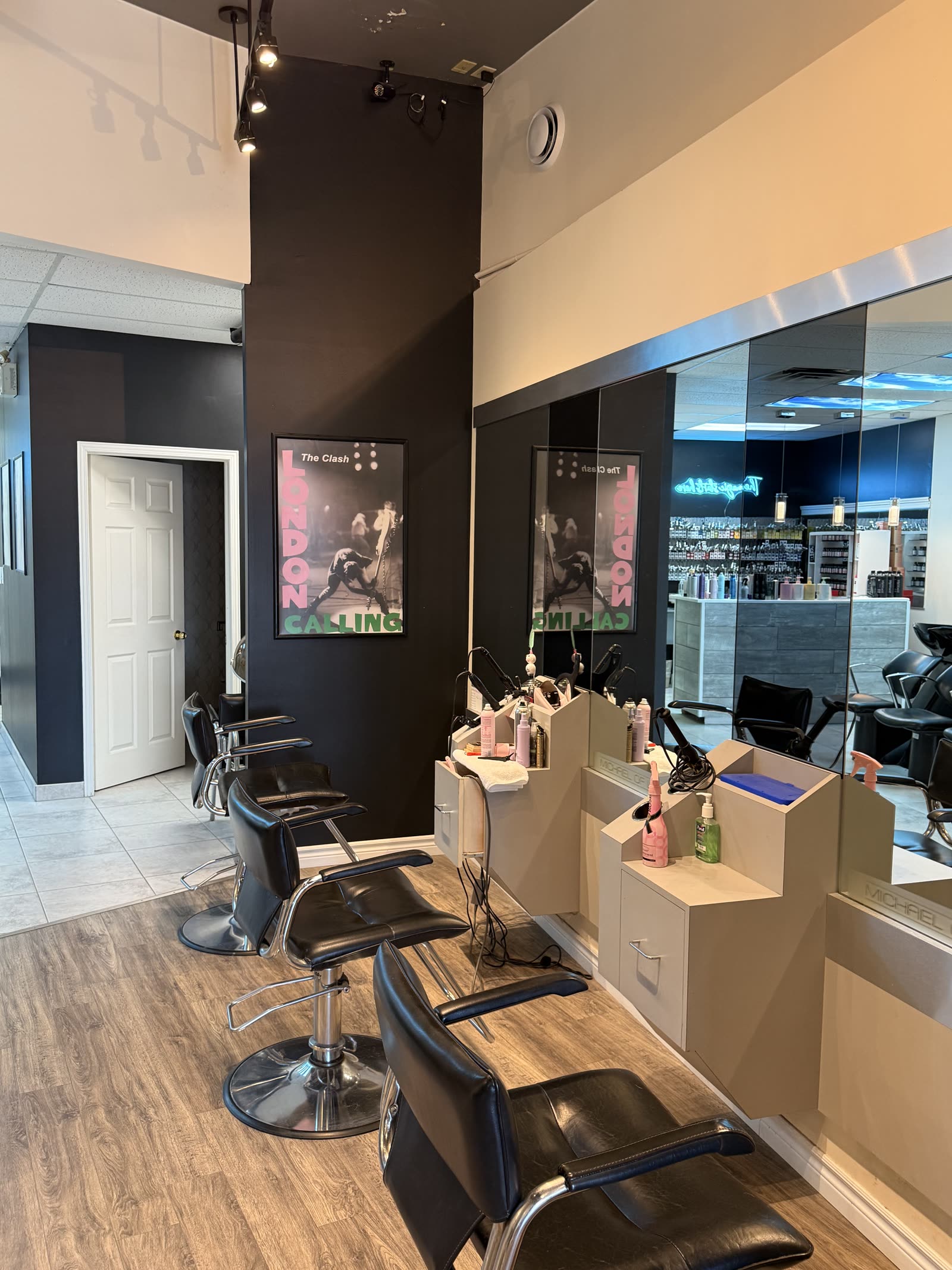 Styling chairs beneath a London Calling poster at Michael of London Salon in the north end of St. Catharines